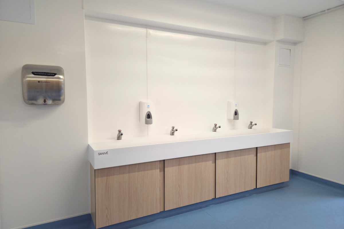 Automatic hand dryers, ceramic wash trough and push taps for sustainable washroom solution for primary school